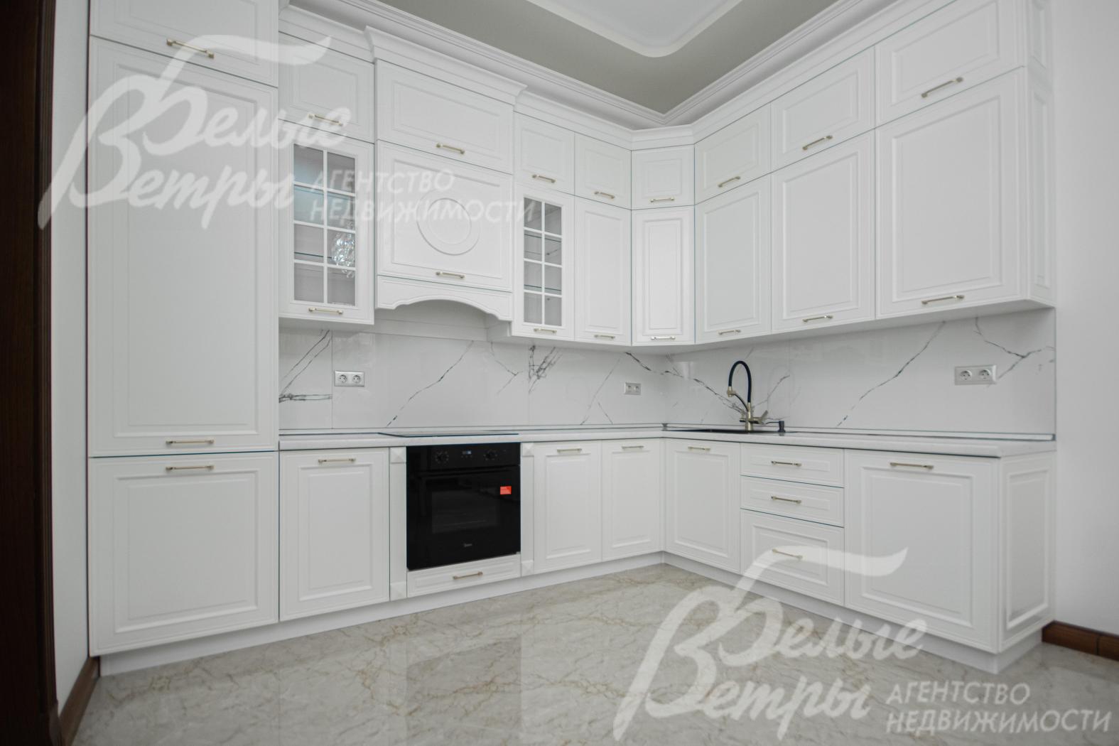 Кухонный гарнитур белого цвета со встроенной техникой