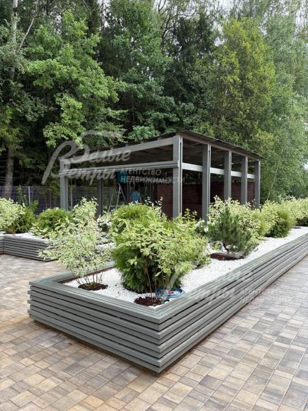 Пространство между кустарниками на клумбах оформлено белой декоративной мульчей