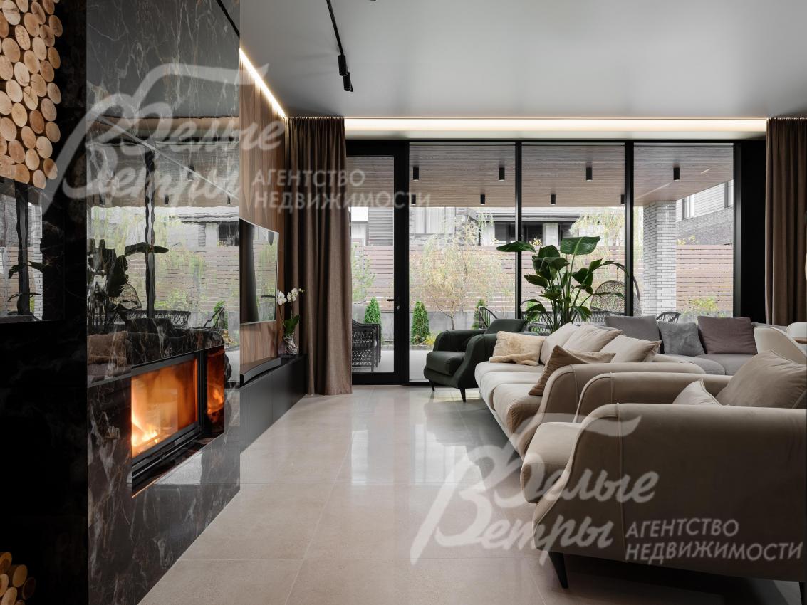 Гостиная с панорамным остеклением, диванной группой и выходом на крытую террасу