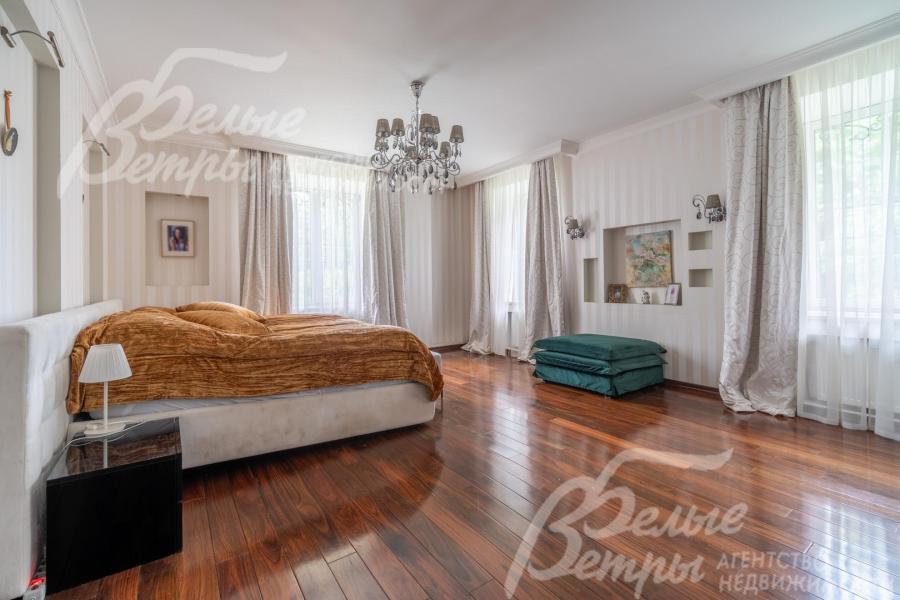 Мастер-спальня на втором этаже с большими окнами, установлен спальный гарнитур