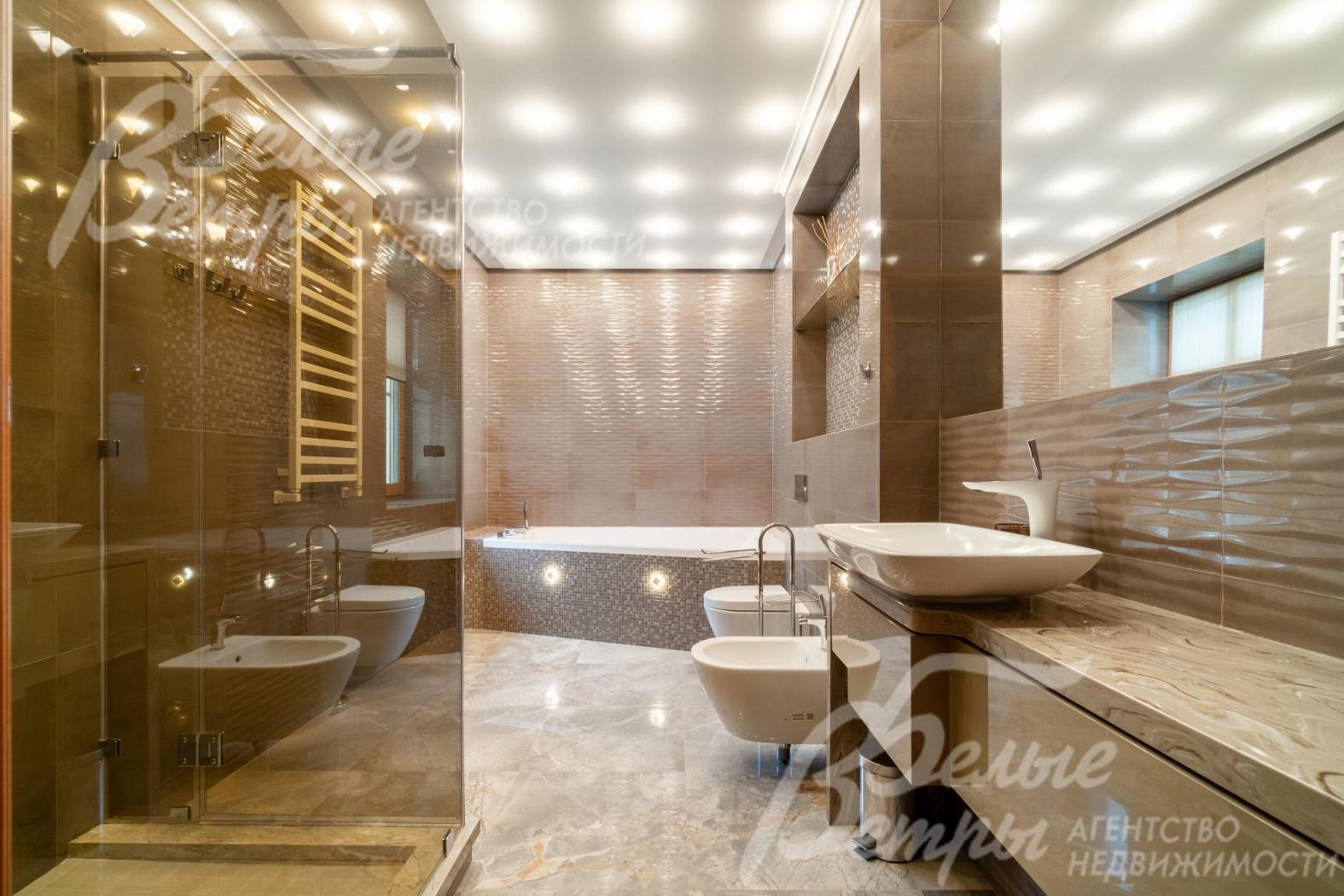 Санузел мастер-спальни - с душевой, ванной и биде, оформлен в тёплых бежевых тонах